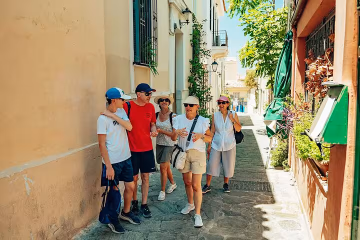 Small group Athens walk through Plaka lanes with local guide, exploring historic streets and tasting bites