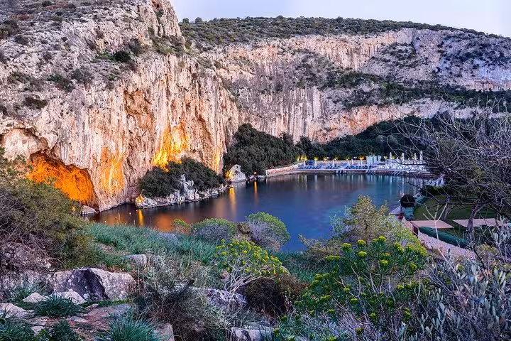 Lake Vouliagmeni lagoon and cliffs at dusk on a luxury private Athens Riviera sunset tour to Sounio