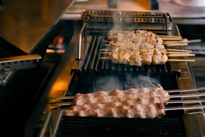 Grilling souvlaki skewers on Athens small group walking food tour, ideal shore excursion for cruisers