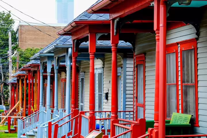 Row of historic shotgun houses with red columns and porches in Atlanta's MLK neighborhood