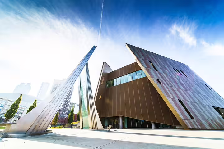 Modern angular bronze building with geometric architecture under blue sky in Atlanta