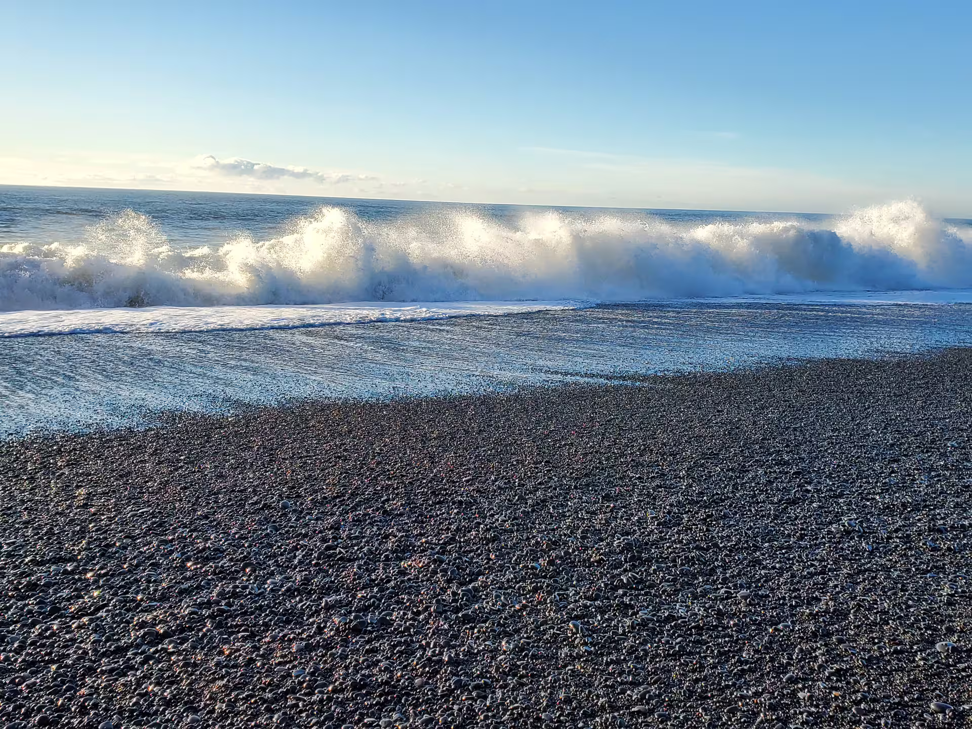 Powerful Atlantic waves crashing on Iceland black sand beach during Katla South Coast day tour from Reykjavik