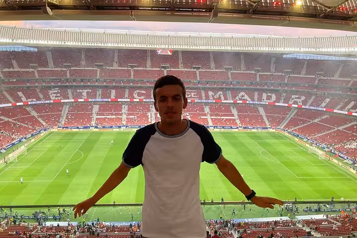 Traveler enjoying panoramic view of Atletico Madrid pitch at Civitas Metropolitano during game experience
