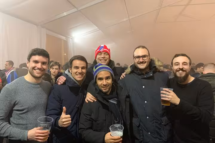 Friends enjoying pre-match drinks on a local Atletico Madrid game experience in Madrid with a host