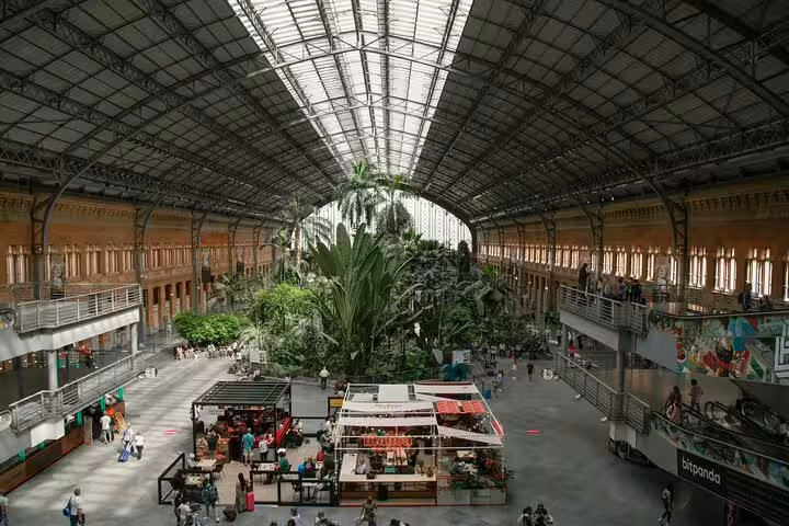 Madrid Atocha train station tropical garden hall, meeting point for private transportation transfer to central Madrid