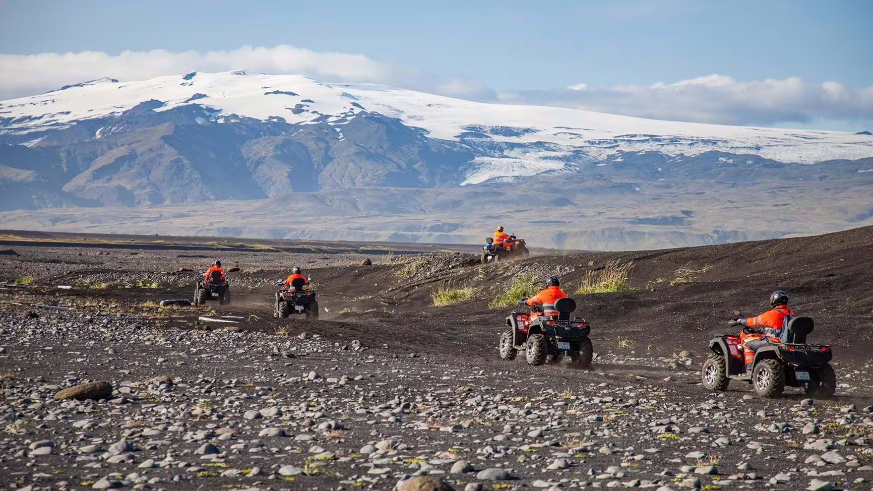 Group ATV ride over volcanic black sands with glacier backdrop on a private South Coast Iceland adventure tour