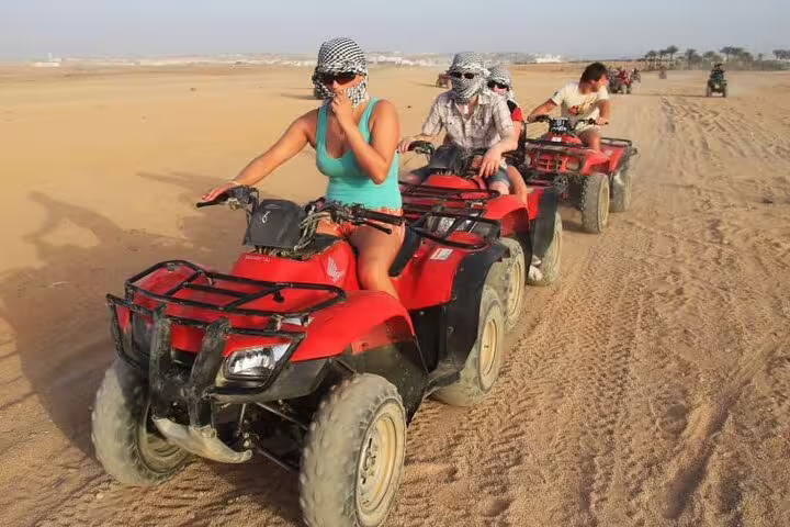 ATV quad bike convoy across Sharm El Sheikh desert, riders in scarves on Red Sea safari adventure tour