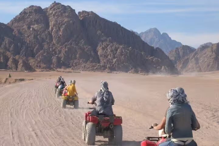 Private ATV quad bike safari from Sharm El Sheikh riding across Sinai desert with mountains backdrop