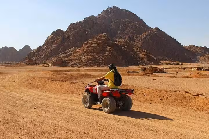 ATV quad biking across Sinai desert dunes near Sharm El Sheikh on Mega Safari Waves and Dunes with lunch