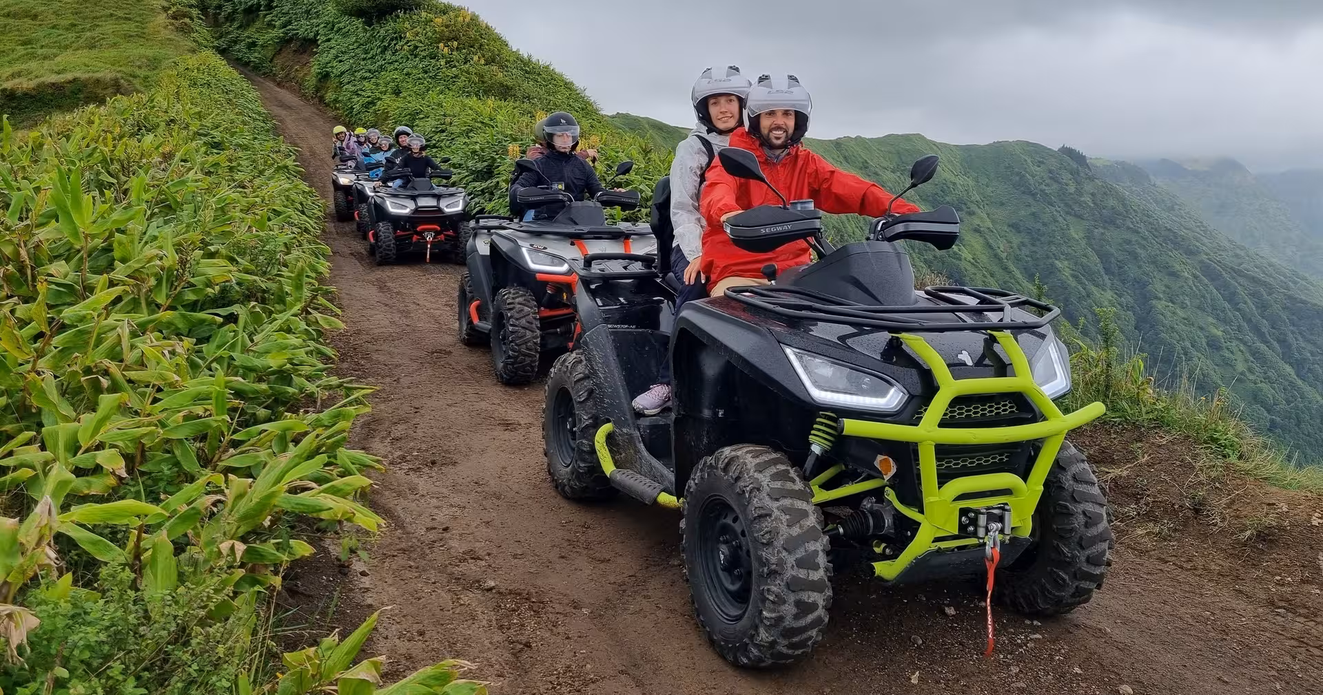 Group ATV convoy on lush ridge trail near Sete Cidades, São Miguel, on a full-day quad tour with lunch included