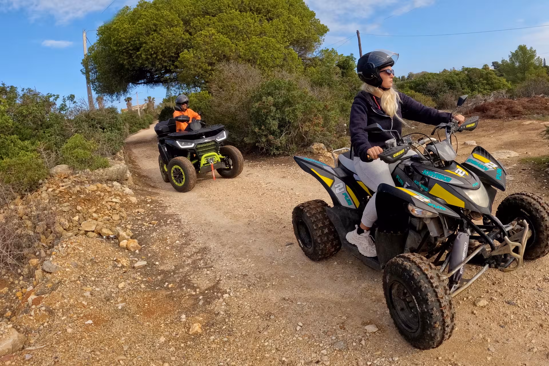 Two people enjoy a scenic ATV ride through the rugged trails of the seven Hanging Valleys, showcasing adventure tourism.
