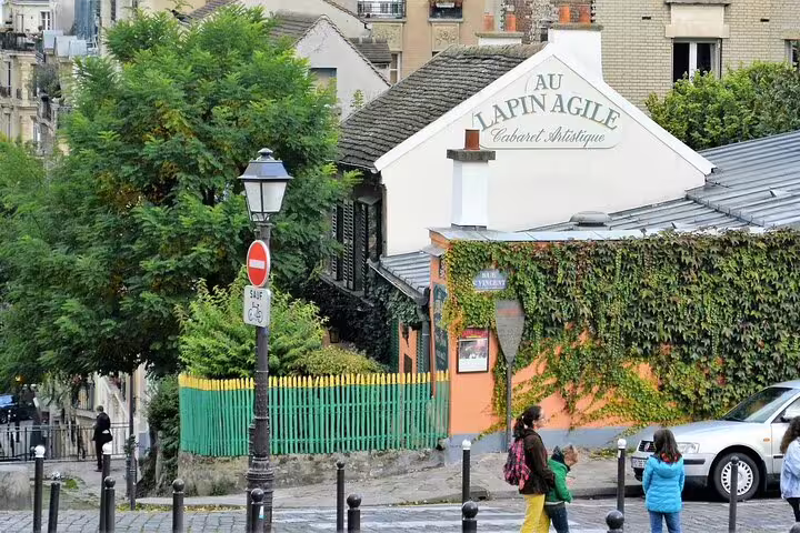 Au Lapin Agile cabaret artistique on a cobblestone street in Montmartre, Paris