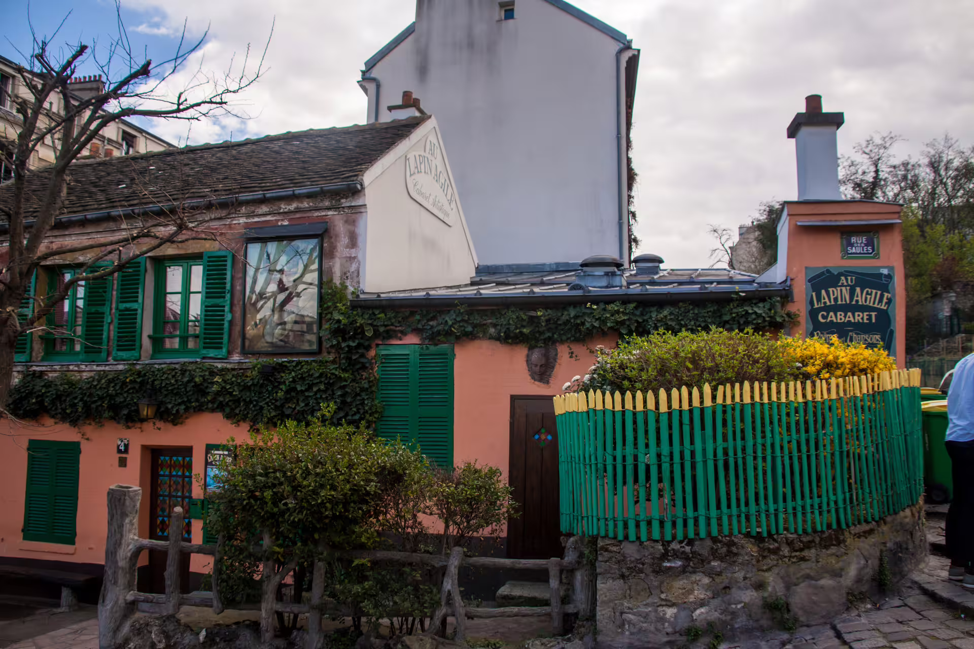 Au Lapin Agile cabaret in Montmartre Paris with pink facade and green shutters