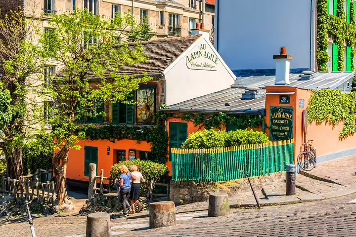 Charming view of Au Lapin Agile cabaret in Montmartre, showcasing Parisian culture on a private full-day tour including the Eiffel Tower.