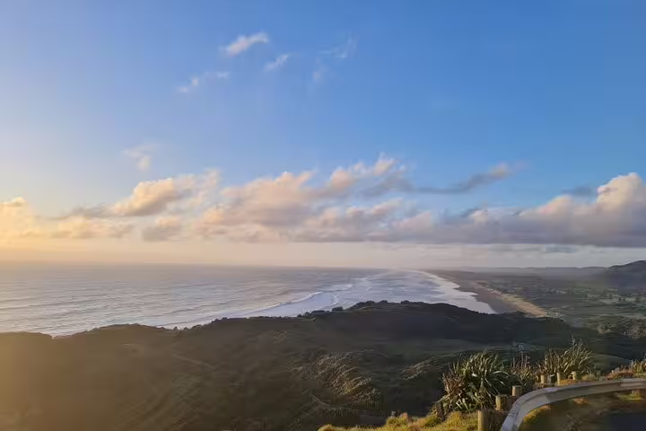 Breathtaking view of Auckland coastline during sunset, perfect for romantic tours with winery visits and thermal pools.
