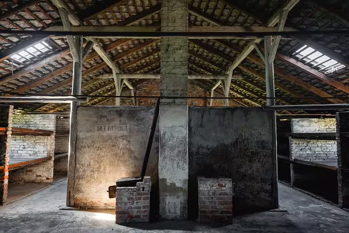 Interior of Auschwitz-Birkenau barracks with wooden roof beams, seen on a private round-trip tour from Krakow