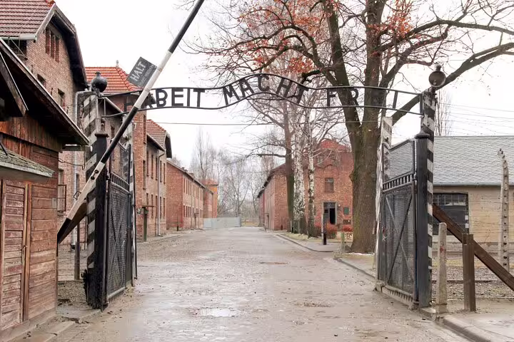 Auschwitz I entrance gate with Arbeit Macht Frei sign on Krakow private round-trip tour