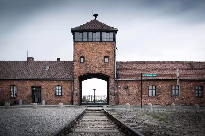 Auschwitz I main gate and railway tracks at Auschwitz-Birkenau Memorial on private tour from Krakow
