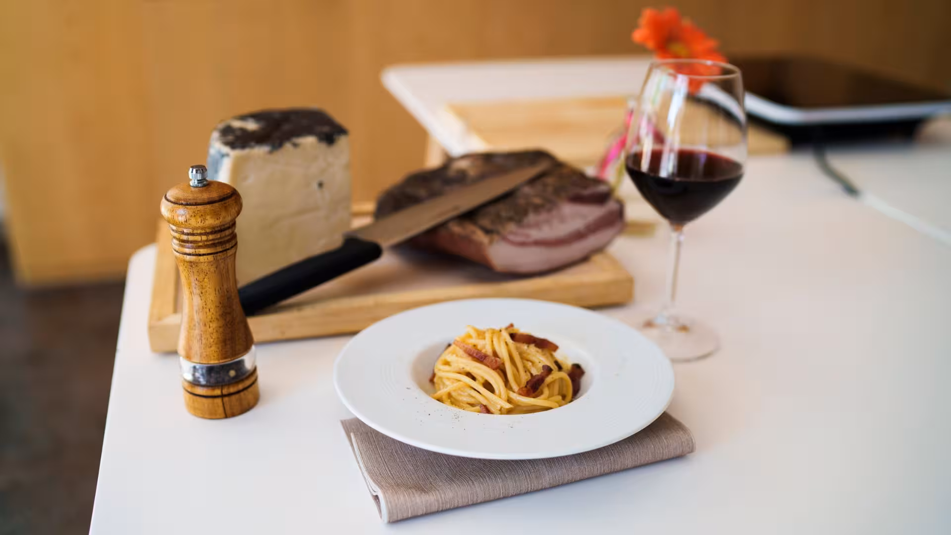 Authentic pasta carbonara with pancetta, pecorino cheese, and red wine in Olbia cooking class setting.