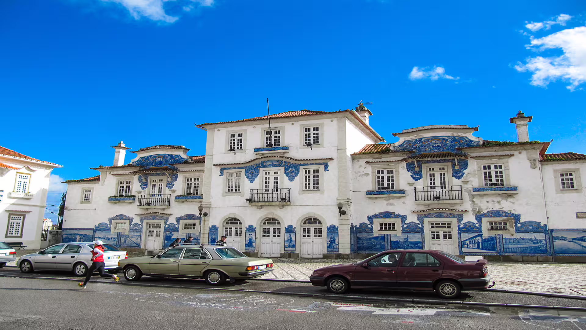 Historic building in Aveiro featuring traditional azulejo tiles under a clear sky, highlighting Portuguese architectural charm.