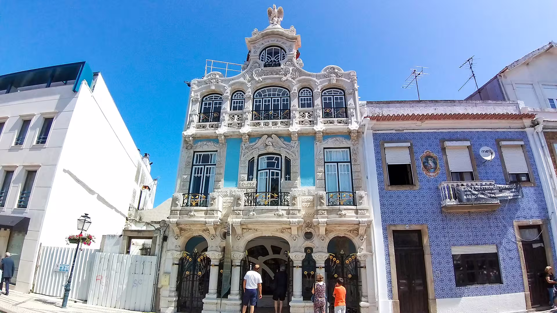 Ornate blue and white building facade in Aveiro showcases intricate architecture on a sunny day, perfect for cultural tours.