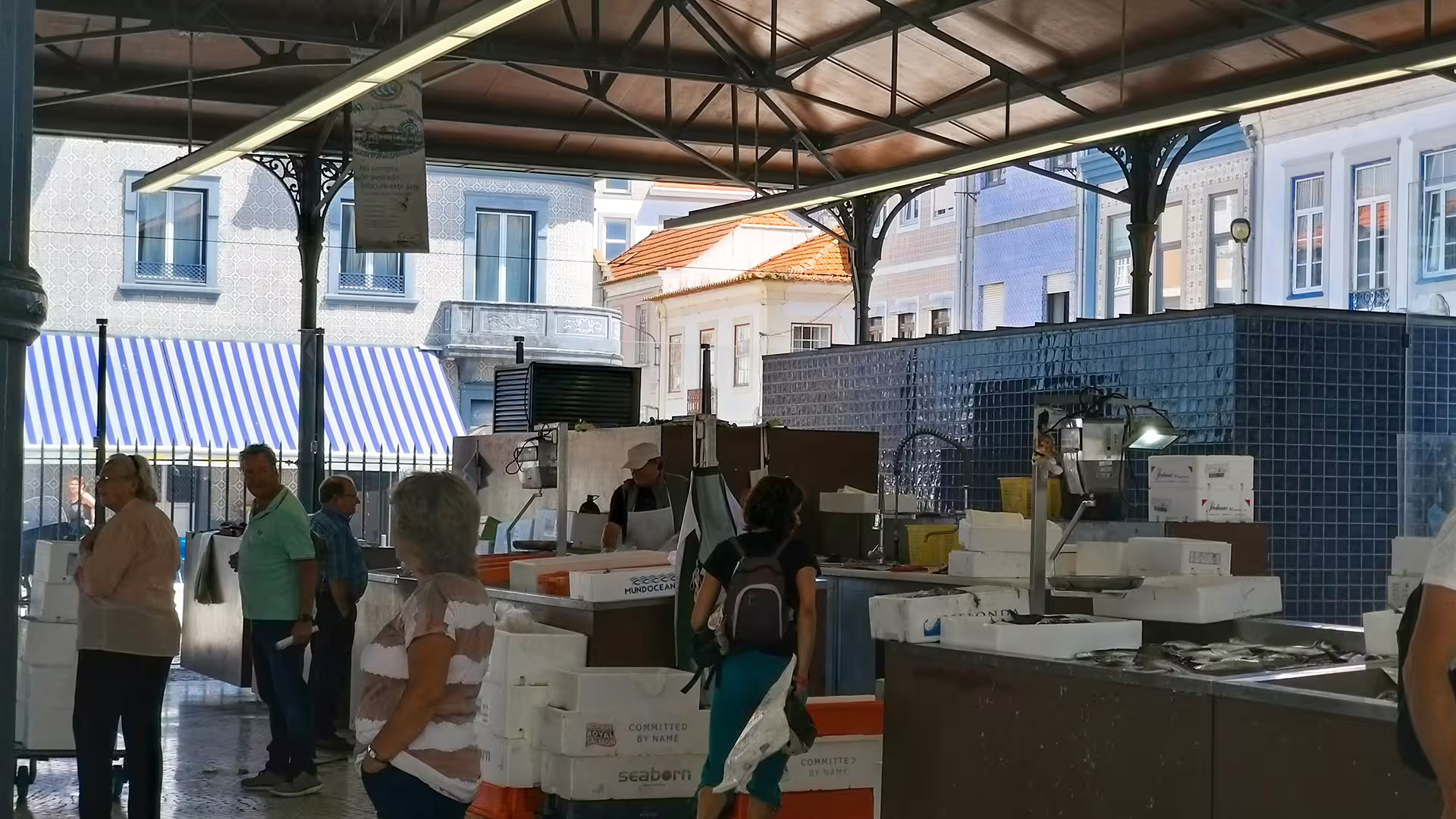 Visitors explore a bustling fish market in Aveiro, showcasing local culture during the Costa Nova striped houses private tour.