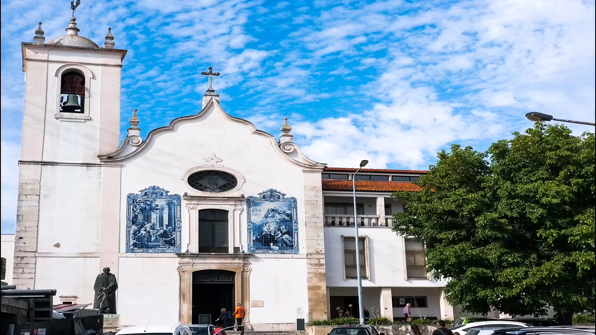 Historic church with ornate blue tiles in Aveiro, Portugal, under a vibrant sky, featured on private Costa Nova tour.
