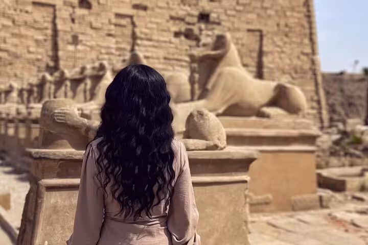 Visitor facing the Avenue of Sphinxes at Karnak Temple, part of a private full-day Luxor and Valley of the Kings tour from Hurghada