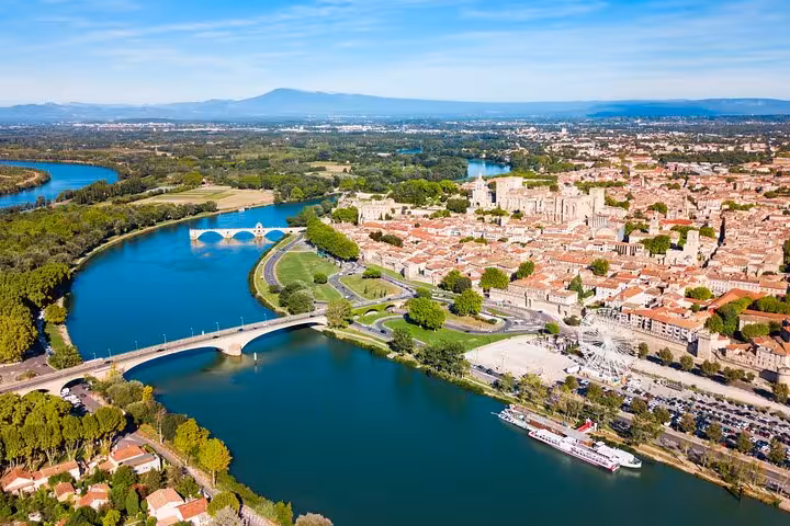 Aerial view of Avignon showcasing the Rhône River and Pont Saint-Bénézet, ideal for exploring on a guided city walk.