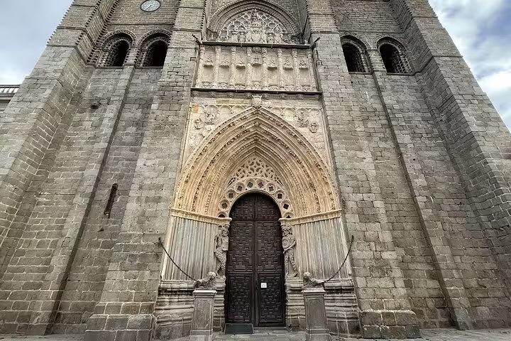 Gothic entrance of Ávila Cathedral with ornate arch, visited on an Avila half day private minivan tour