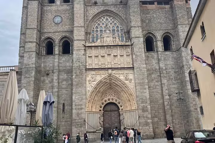 Avila Cathedral Gothic stone facade in old town, stop on Avila and Segovia private minivan tour from Madrid