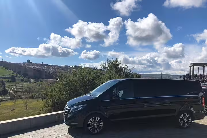 Private minivan at Avila viewpoint with medieval city walls and countryside on an Avila half-day tour