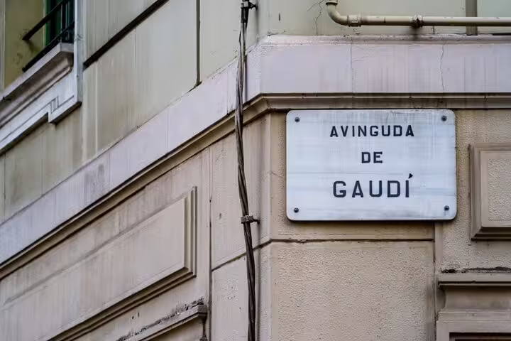 Street sign for Avinguda de Gaudí mounted on a building wall in Barcelona