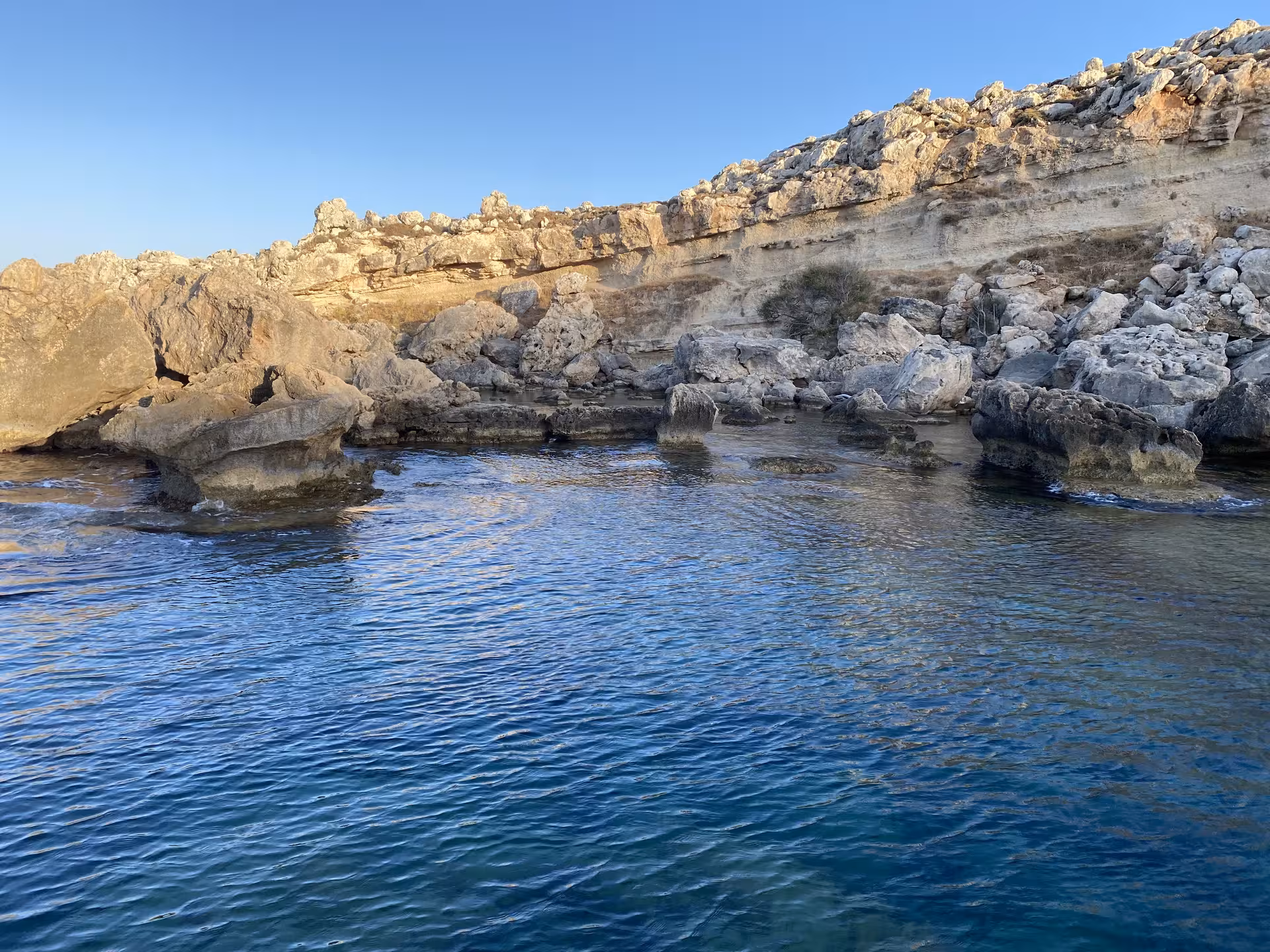 Crystal-clear water by rugged limestone cliffs, scenic viewpoint on the Axopar 25 CT sunset cruise route