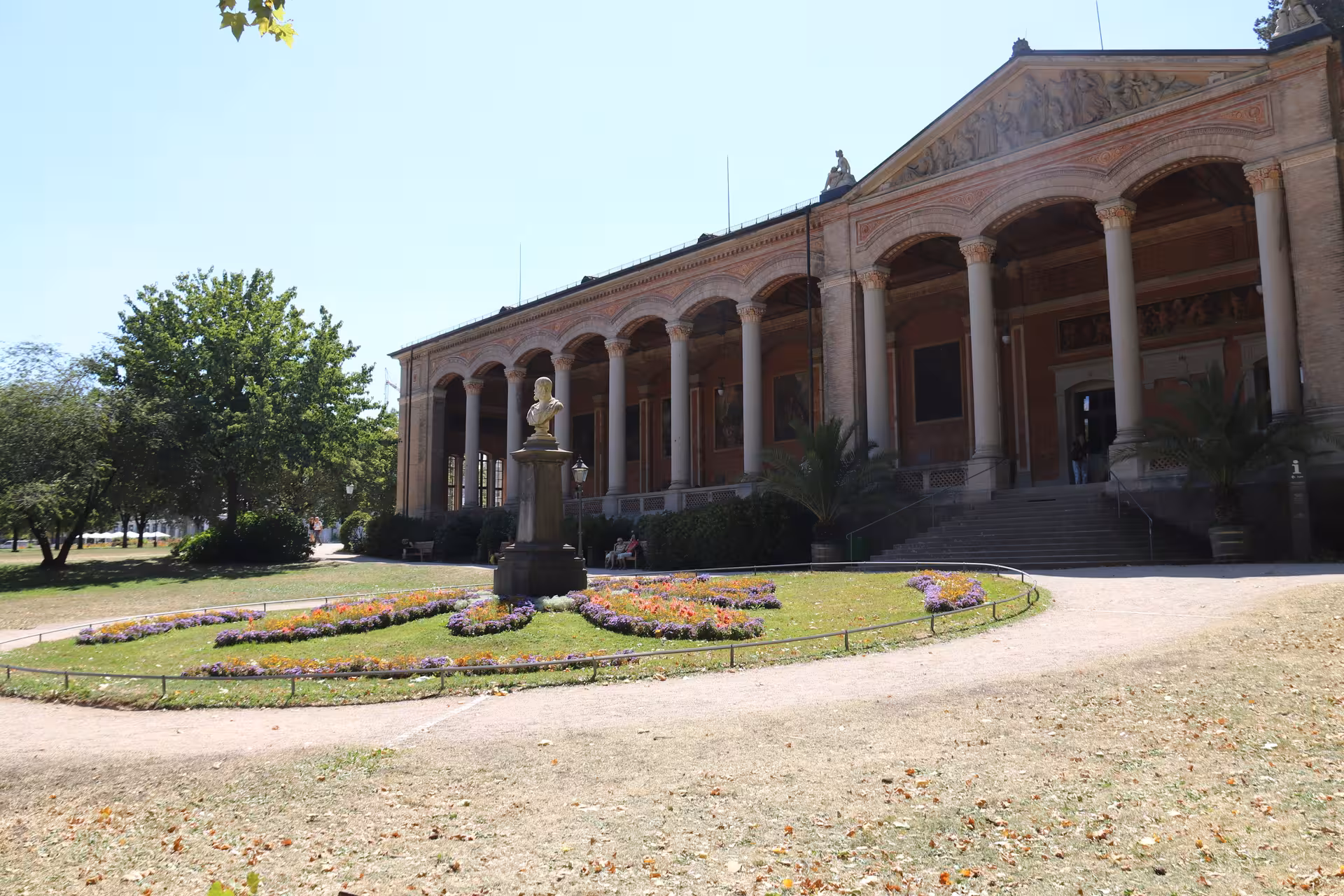 Neoclassical Trinkhalle pump room with columned facade and colorful flower garden in Baden-Baden, Germany