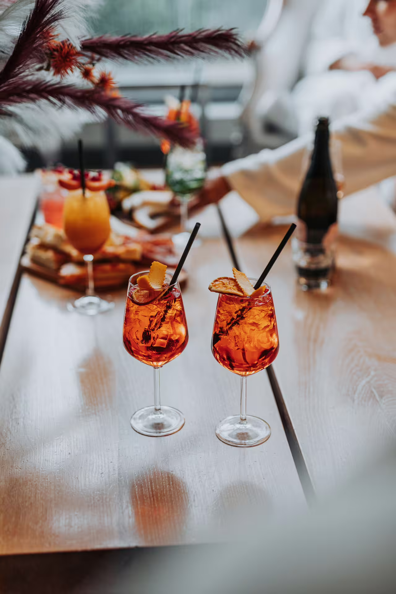 Two Aperol spritz cocktails on spa table, part of Bagno di Romagna 2-hour thermal pool entry with aperitif