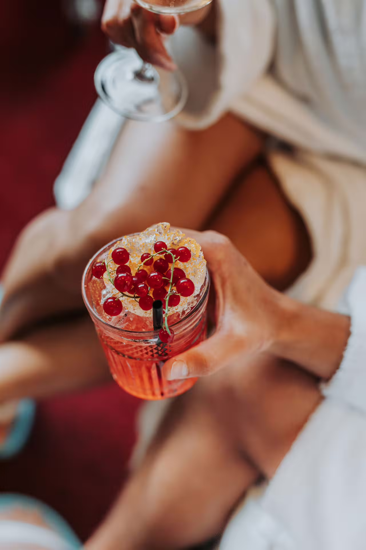 Hand holding berry cocktail aperitif during Bagno di Romagna thermal spa visit, 2-hour pool entry Mon-Wed