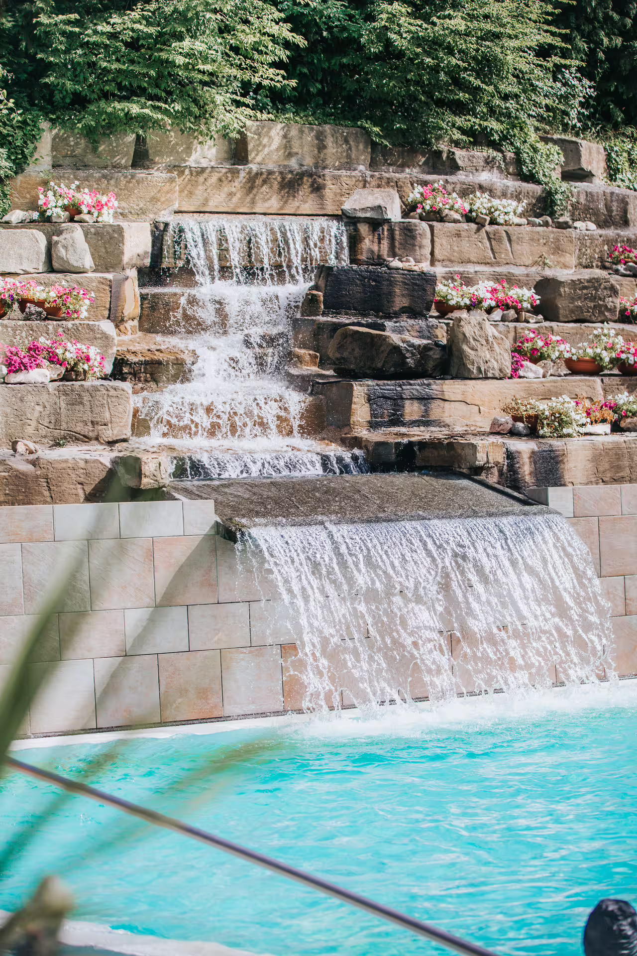 Outdoor thermal pool waterfall at Bagno di Romagna spa, included 2-hour entry with aperitif and massage