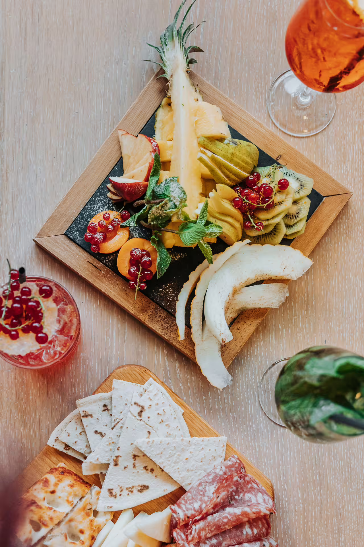 Italian aperitif spread with fruit, salumi and drinks after Bagno di Romagna thermal pool entry, Fri-Sun