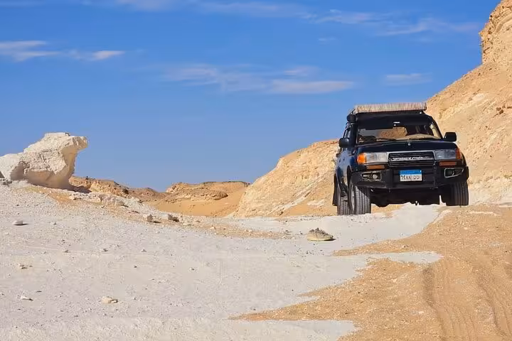 4x4 jeep driving through White Desert near Bahariya Oasis on a 3-day eco camping safari tour, Egypt