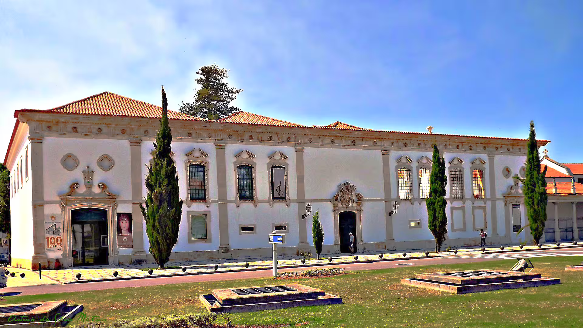Historic building in Aveiro, Portugal, showcasing ornate architecture, lush surroundings, and cultural significance on a sunny day.