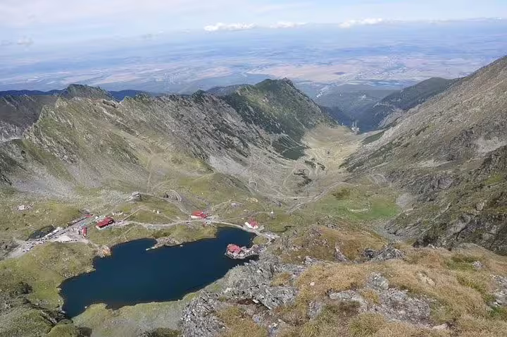 Aerial view of Balea Lake surrounded by Fagaras Mountains along Transfagarasan Road, Romania