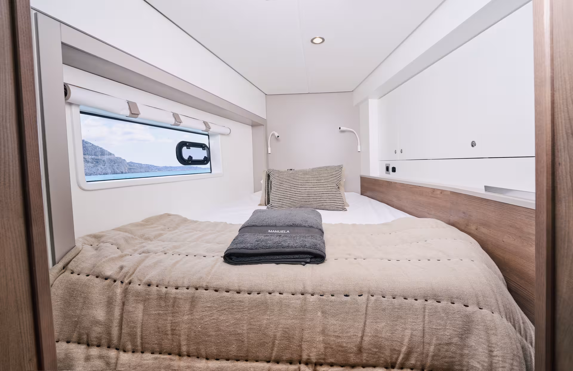 Modern double cabin with sea-view window on Bali 4.2, perfect for a private luxury catamaran Barcelona tour