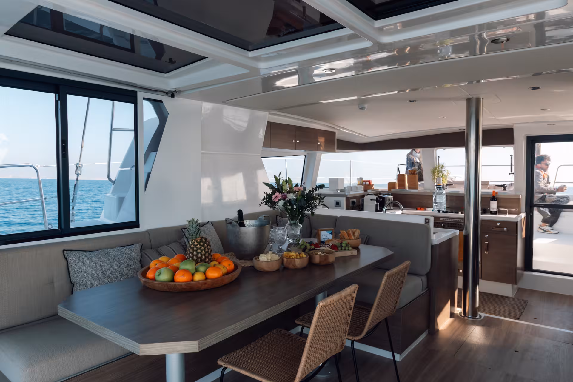 Bali 4.2 luxury catamaran interior dining area with snacks and sea views on private Barcelona cruise