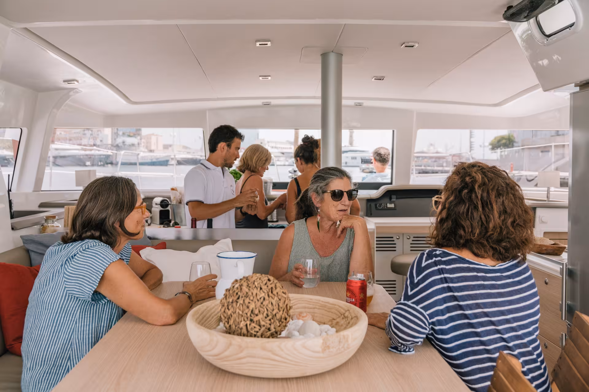 Guests relax in the Bali 4.1 catamaran lounge during a 4-hour private luxury sail from Barcelona