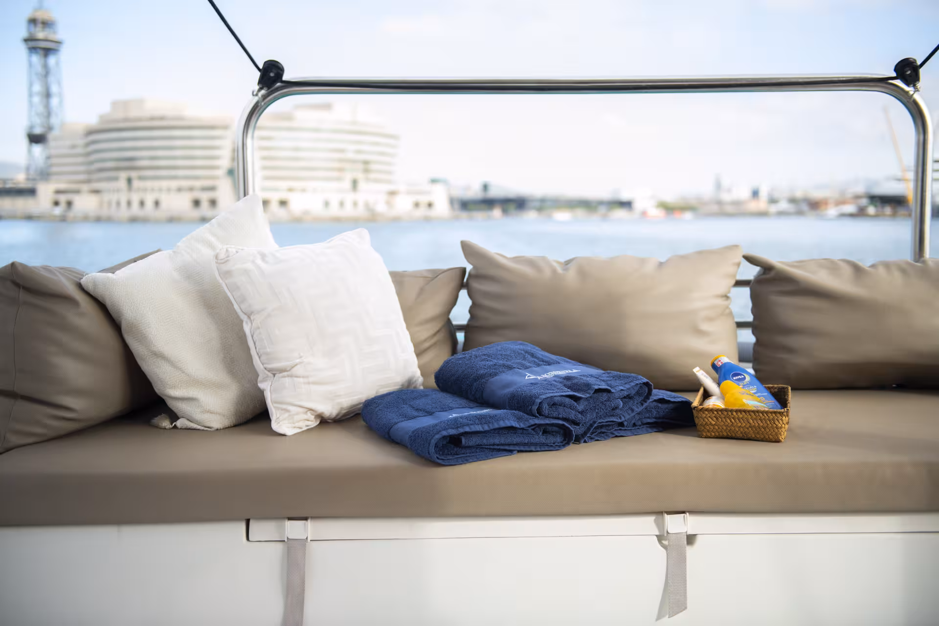 Relaxing cushioned lounge with towels on Bali 4.1 catamaran during a private 2-hour Barcelona cruise