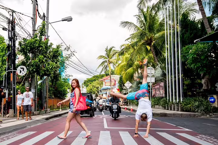 Fun Bali street photo shoot with private vacation photographer, traveler doing a handstand at a crosswalk