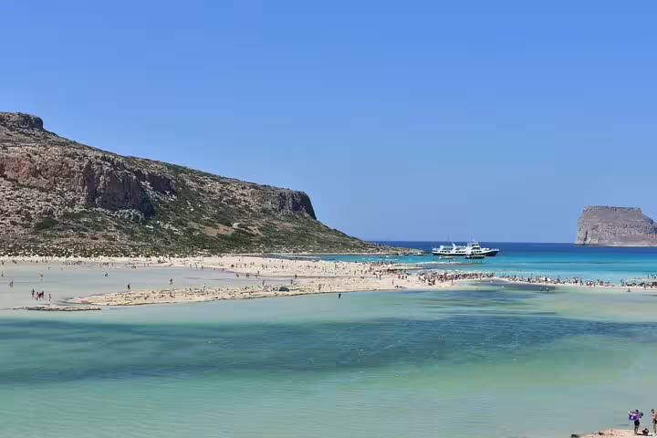 Boats dock near the stunning Balos Lagoon, offering picturesque views and a serene atmosphere for visitors.