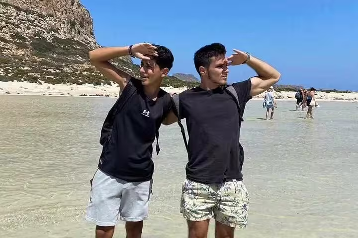 Two visitors enjoying the scenic view at Balos Lagoon during a private tour, highlighting adventure and exploration.