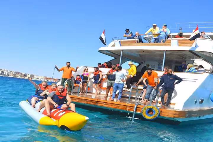 Banana boat water sports from Hurghada yacht on Eden Island day trip in Red Sea with lunch onboard